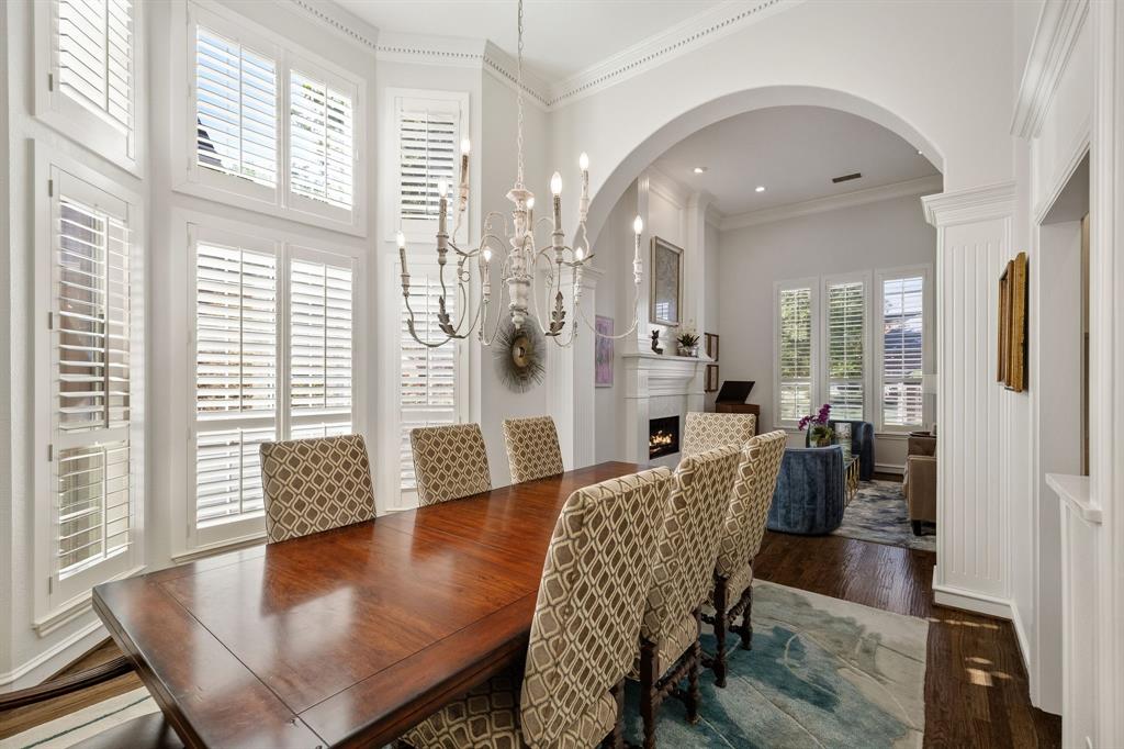 Designer chandelier, plantation shutters, access to the kitchen & wet bar.