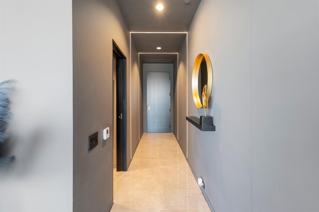 Recessed ceiling lighting, linear strip lighting, flush-mount doors, and tile flooring Recessed ceiling lighting, linear strip lighting, flush-mount doors, and tile flooring