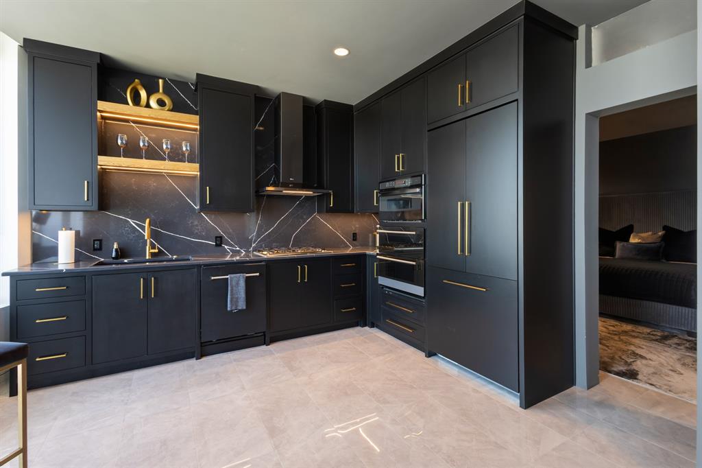 Integrated black cabinetry with gold-tone hardware Integrated black cabinetry with gold-tone hardware