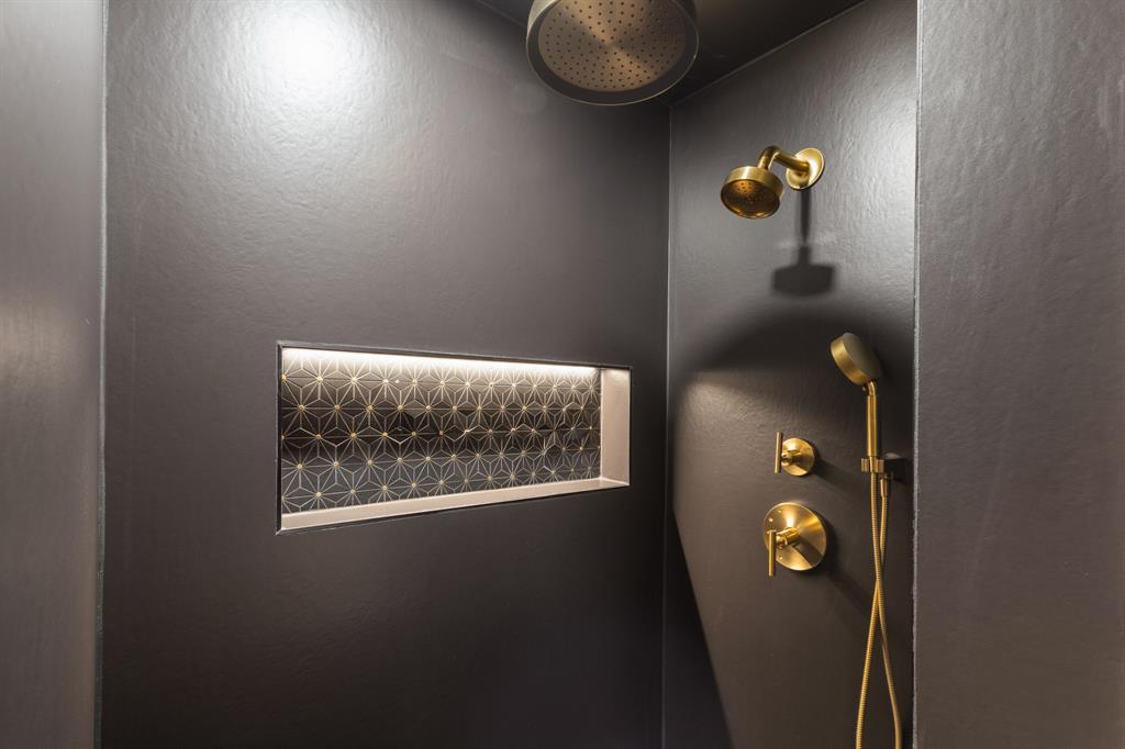 Integrated shower niche with geometric tile and accent lighting