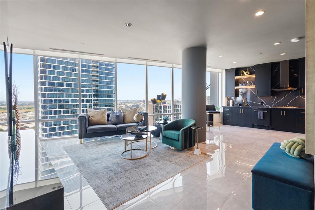 Expansive floor-to-ceiling windows, sleek polished flooring, contemporary kitchen with dark cabinetry, integrated range hood, and distinctive backsplash Expansive floor-to-ceiling windows, sleek polished flooring, contemporary kitchen with dark cabinetry, integrated range hood, and distinctive backsplash