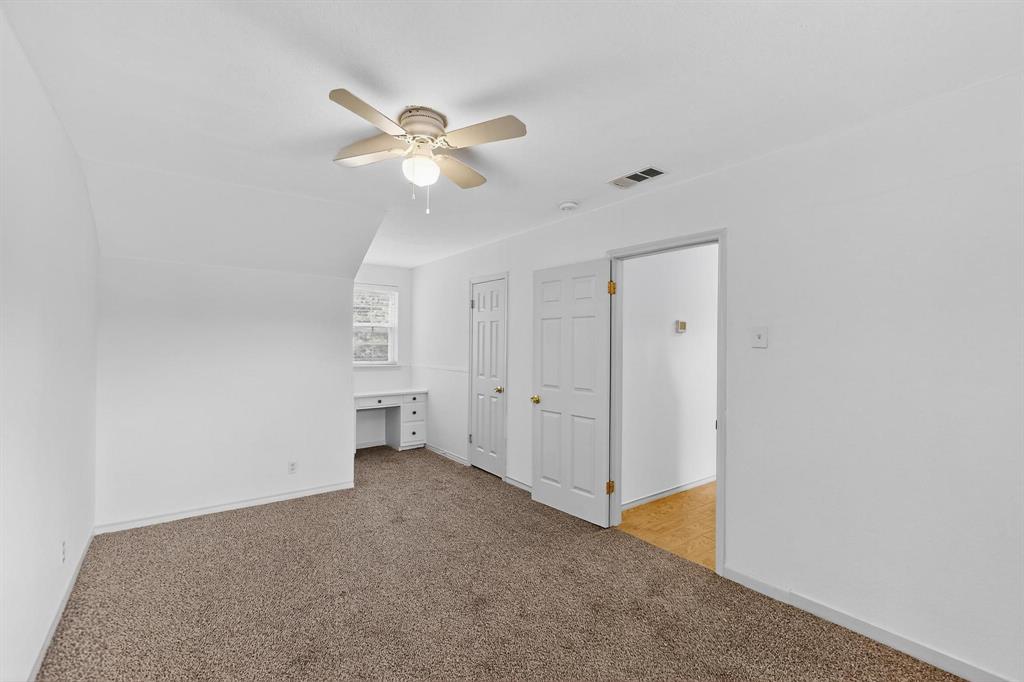 Bonus room featuring light colored carpet and ceiling fan