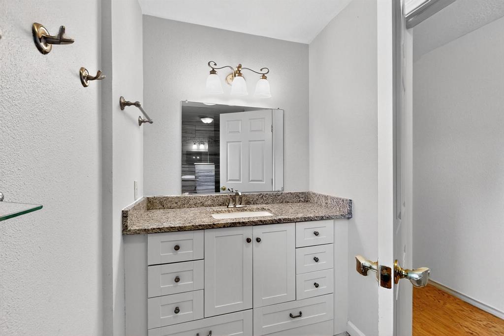 Bathroom featuring vanity and wood finished floors