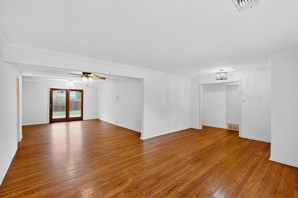 Unfurnished living room with crown molding, light wood finished floors, and ceiling fan Unfurnished living room with crown molding, light wood finished floors, and ceiling fan