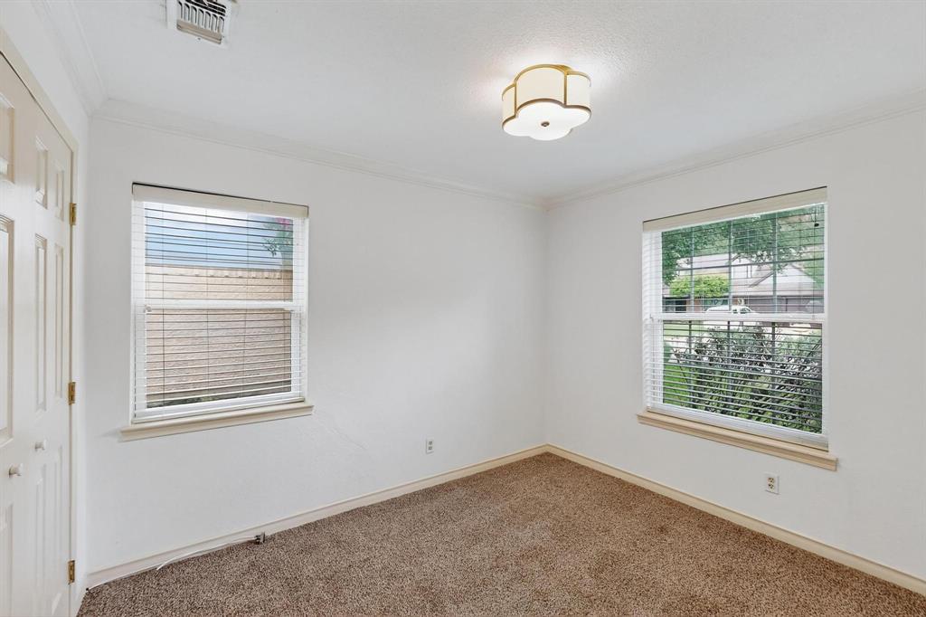 Carpeted spare room with crown molding