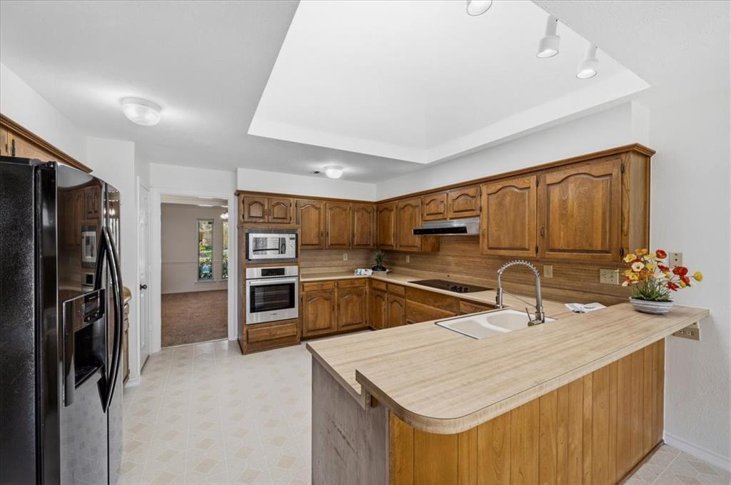 Bosch electric convection wall oven with Panasonic microwave - stainless steel appliances - vent hood vented to attic - lovely track lighting over the breakfast bar