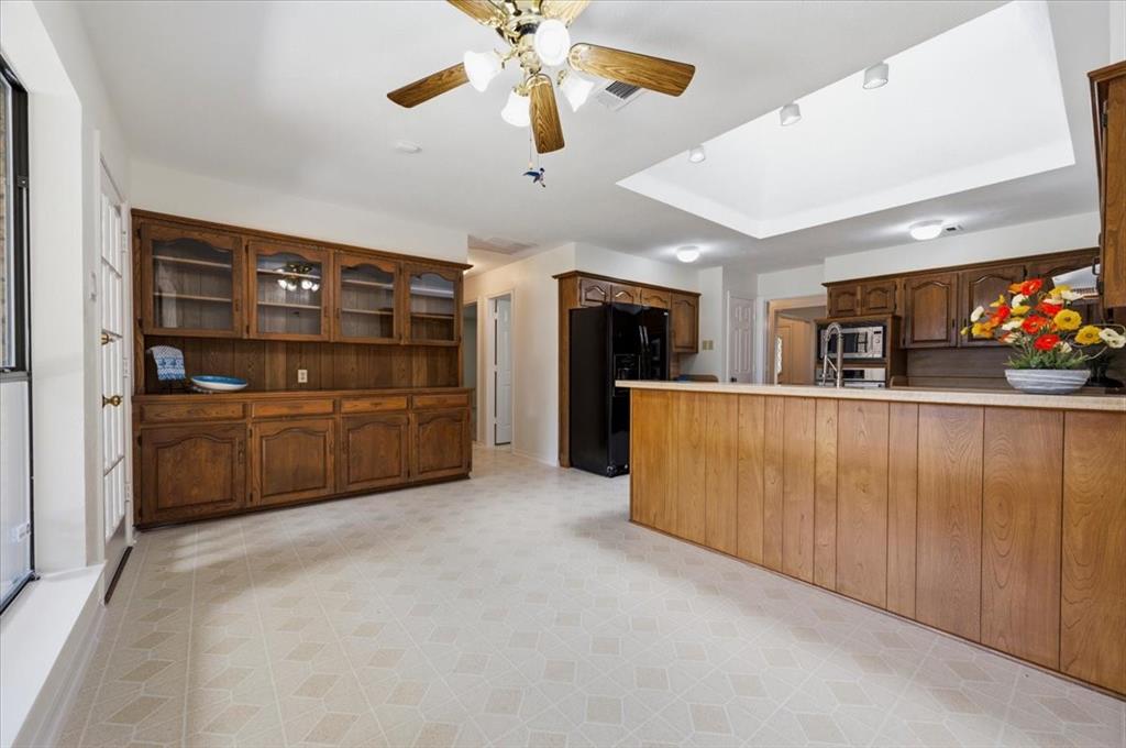 Lovely hutch with lots of storage, glass doors to display special items - ceiling fan in the breakfast area plus a view to the large covered patio