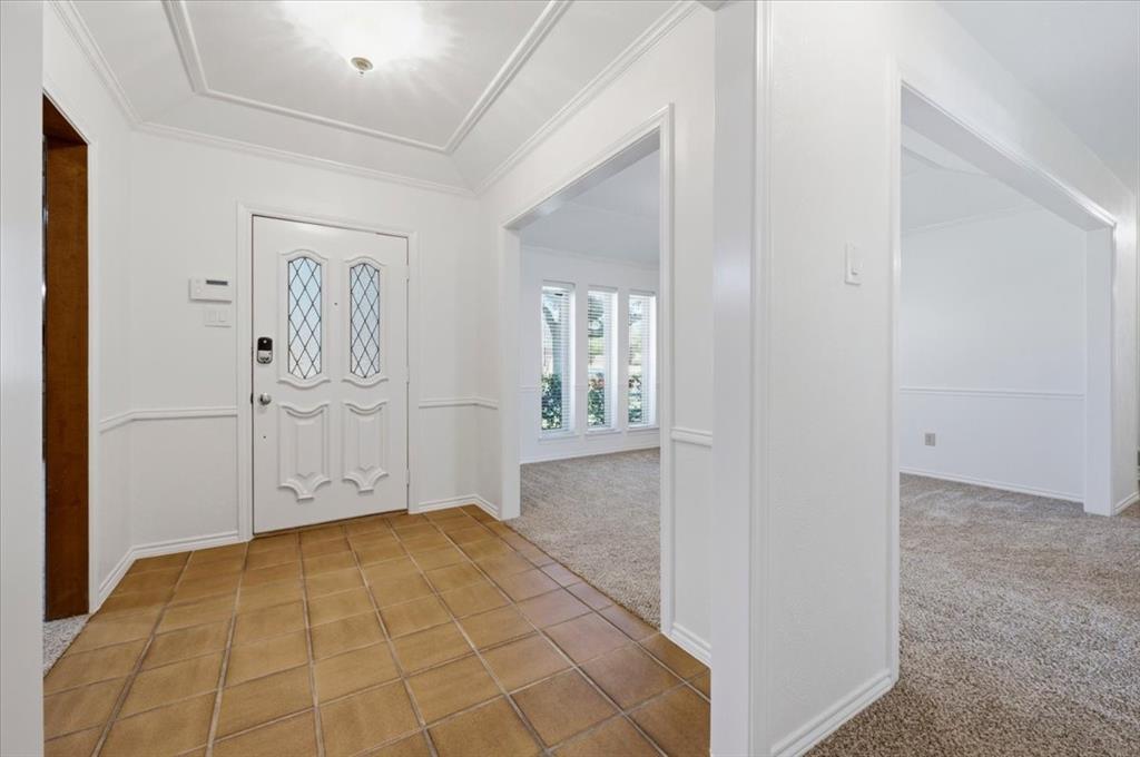 Large walk-in entry area with view and opening to formal dining - total home was painted, walls, ceilings, trim, moldings and new carpeting after painting Large walk-in entry area with view and opening to formal dining - total home was painted, walls, ceilings, trim, moldings and new carpeting after painting