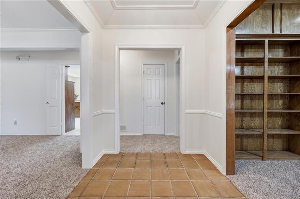 To the right is the living room that features a full wall of bookshelves To the right is the living room that features a full wall of bookshelves