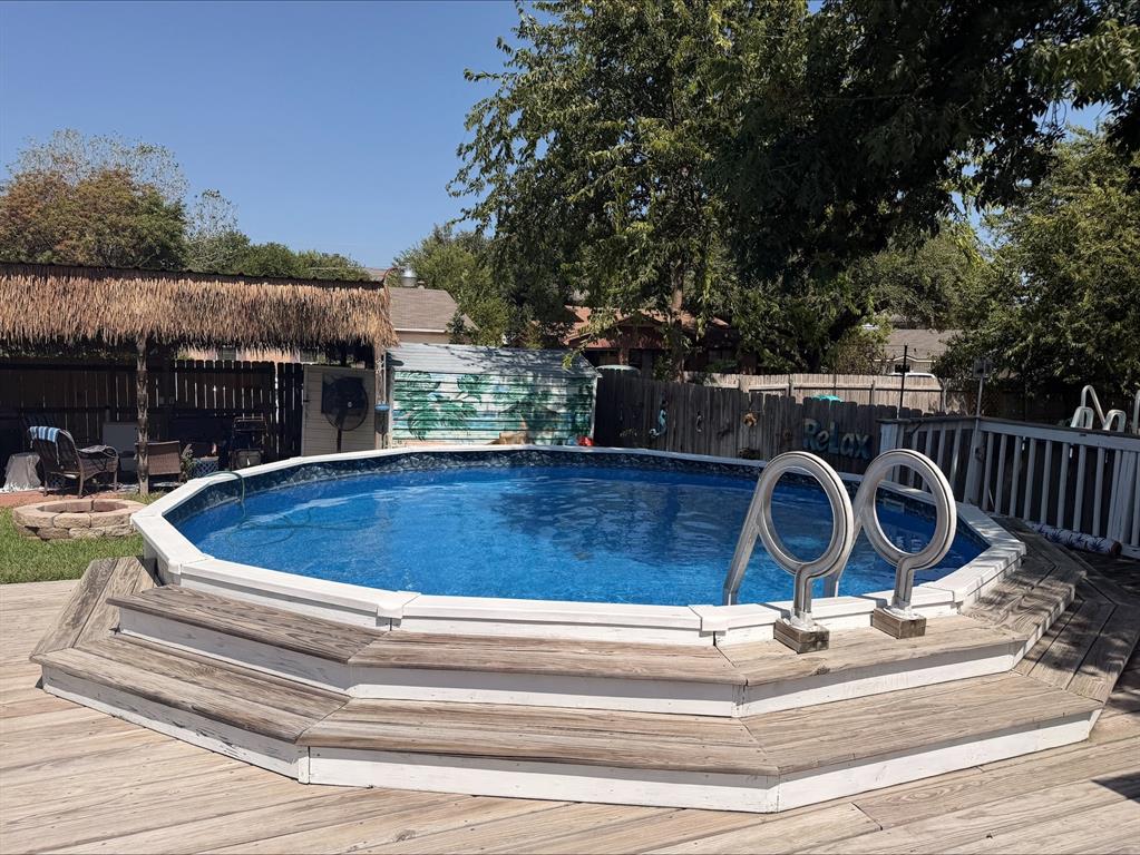Above-ground pool with surrounding wood-finish decking