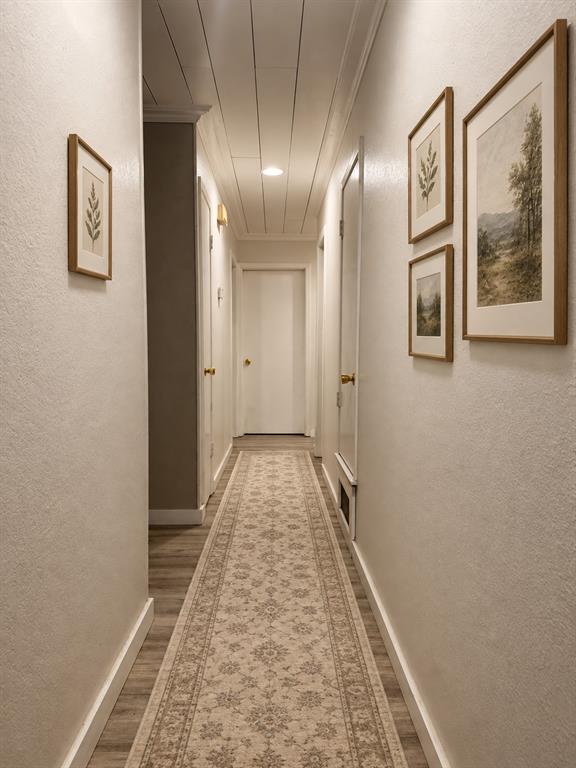 Corridor featuring wood-finish flooring, white shiplap ceiling, and recessed lighting