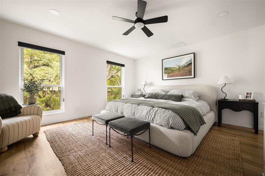 Recessed lighting, wood-finish flooring, and a ceiling fan with integrated lighting