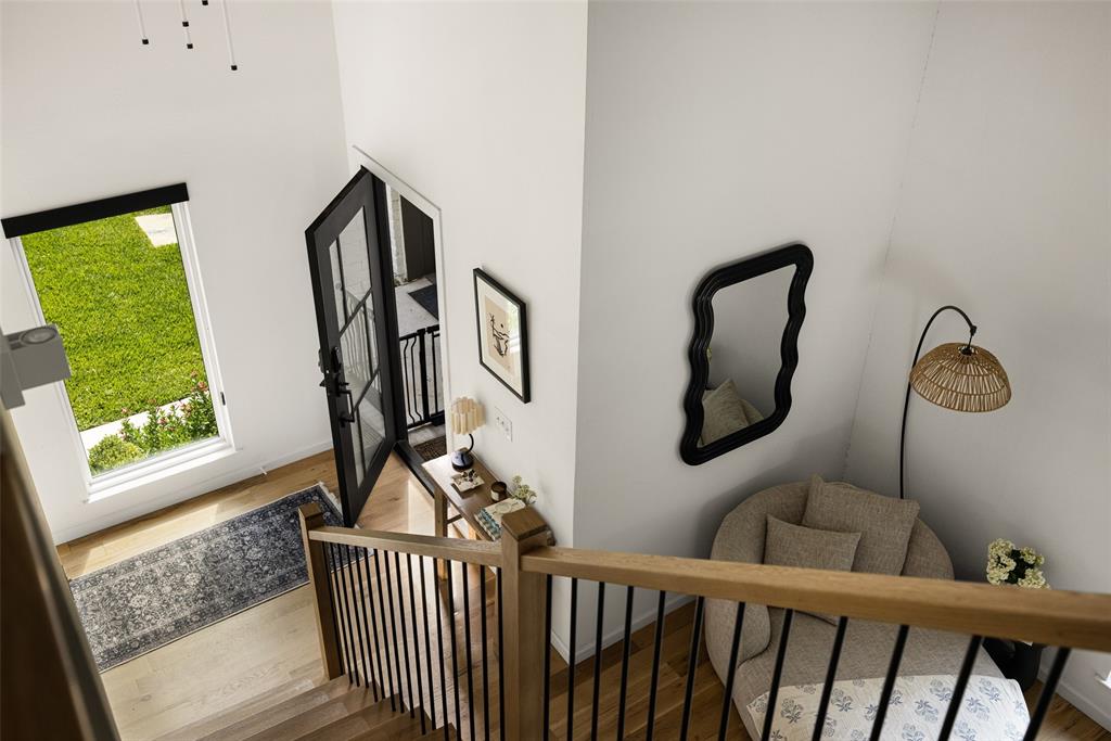 Hardwood flooring, black framed glass door, wood and metal staircase, high ceilings, large window