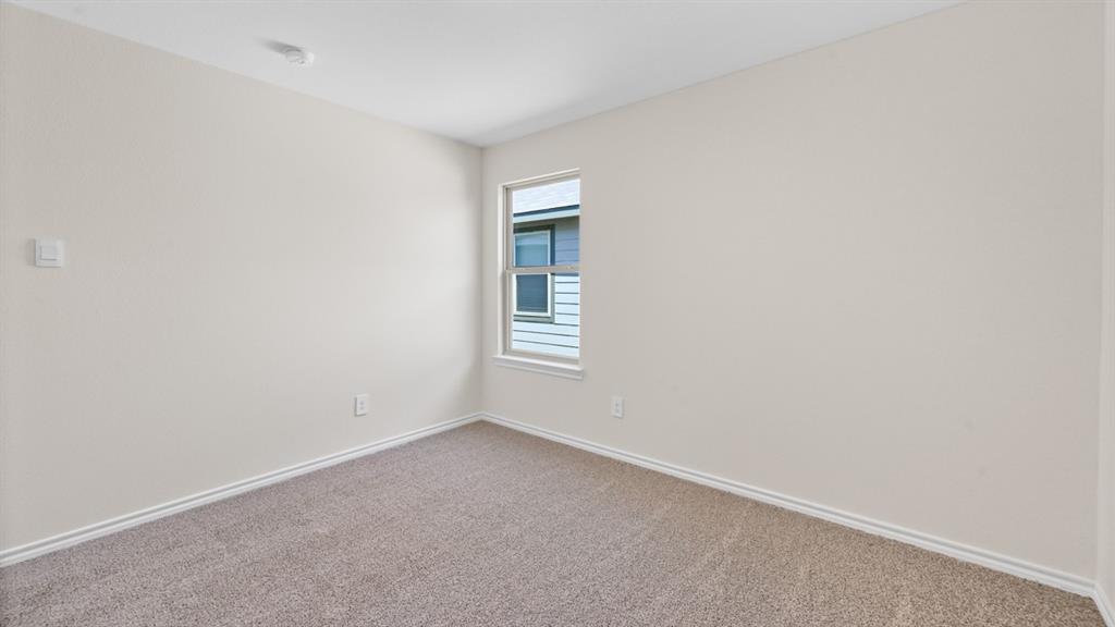 Neutral-toned walls complement the carpeted flooring
