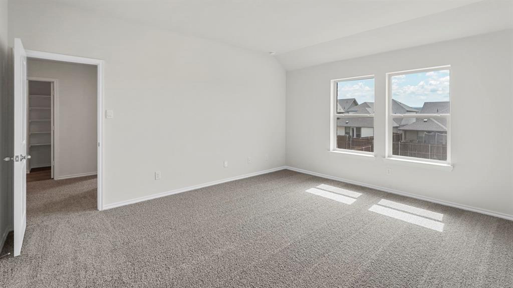 Spacious room featuring neutral carpeting and light gray walls Spacious room featuring neutral carpeting and light gray walls