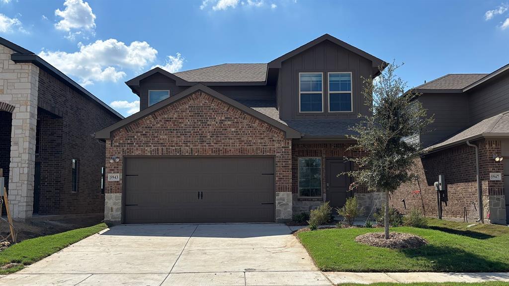 Brick and stone exterior with a two-car garage Brick and stone exterior with a two-car garage