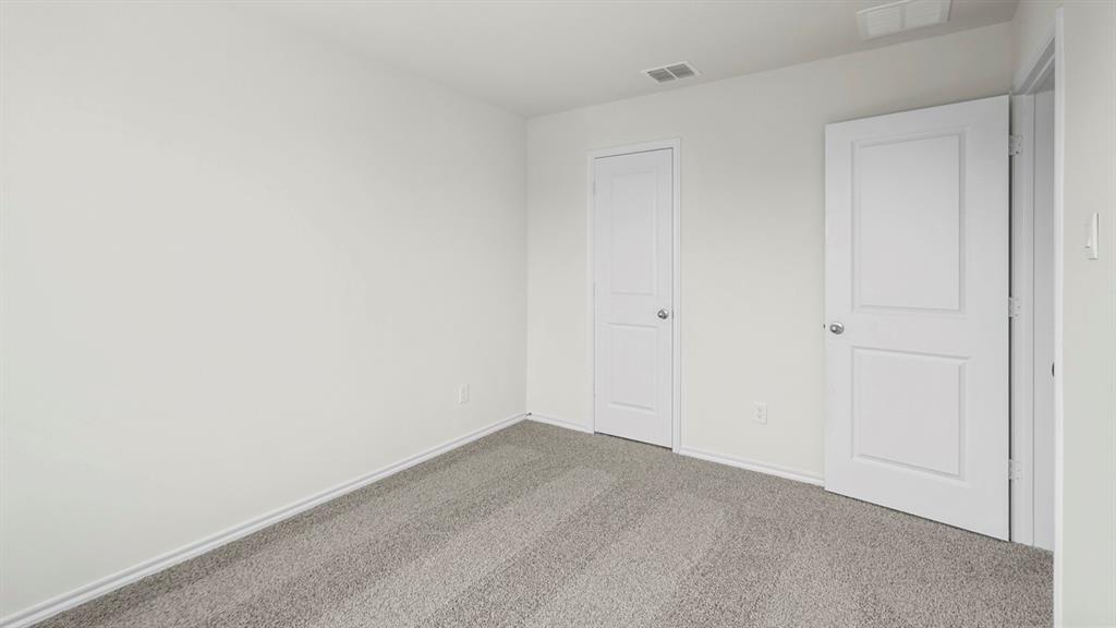 Room with light gray carpet and white walls