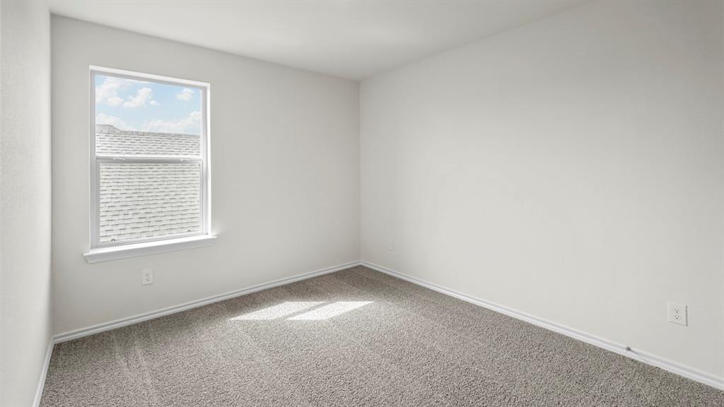 Bright room featuring a single window, light gray carpet, white walls, and white baseboards