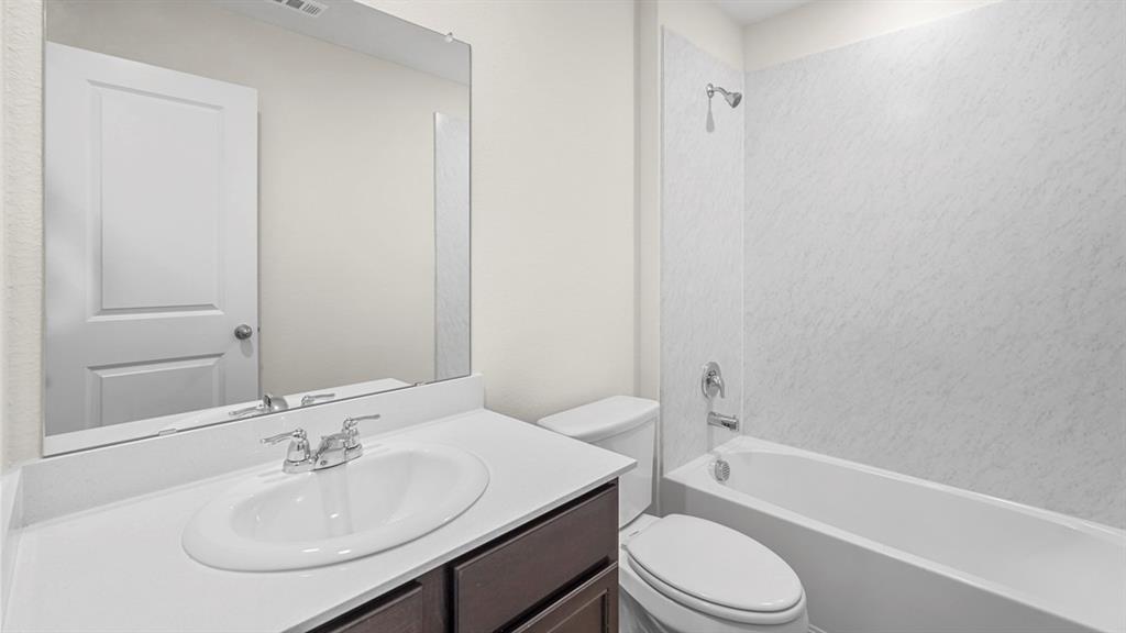 Recessed lighting and a white vanity with an undermount sink and chrome faucet Recessed lighting and a white vanity with an undermount sink and chrome faucet