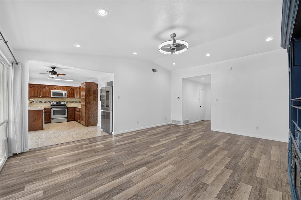 Wood-finish flooring throughout, recessed lighting, and a modern ceiling fixture