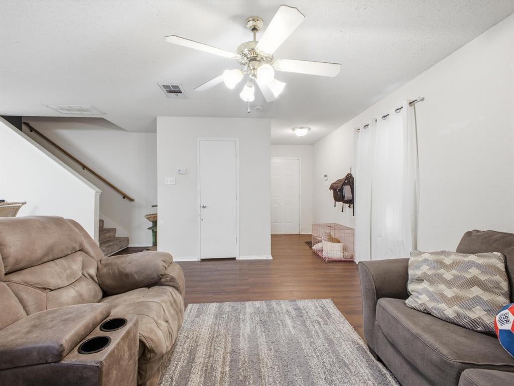 Recessed lighting and a ceiling fan with integrated lighting illuminate the space
