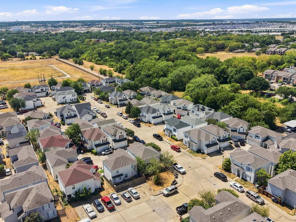 Residential neighborhood with multiple two-story homes and tree-lined surroundings
