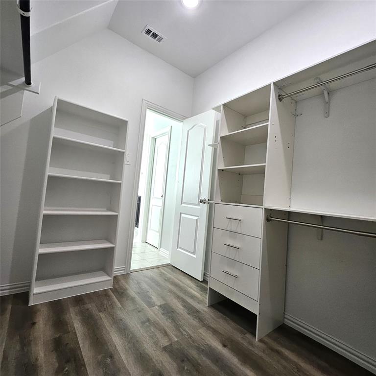 Integrated closet system with shelving, built-in drawers, and hanging rods