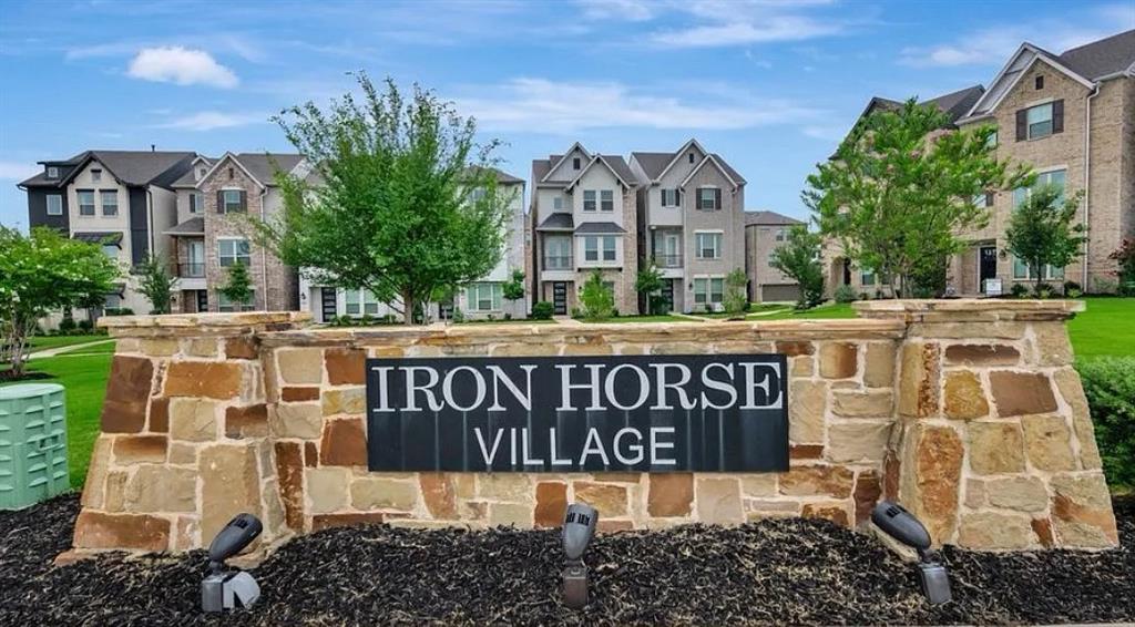 Stone and brick entry monument with integrated lighting and planted landscaping