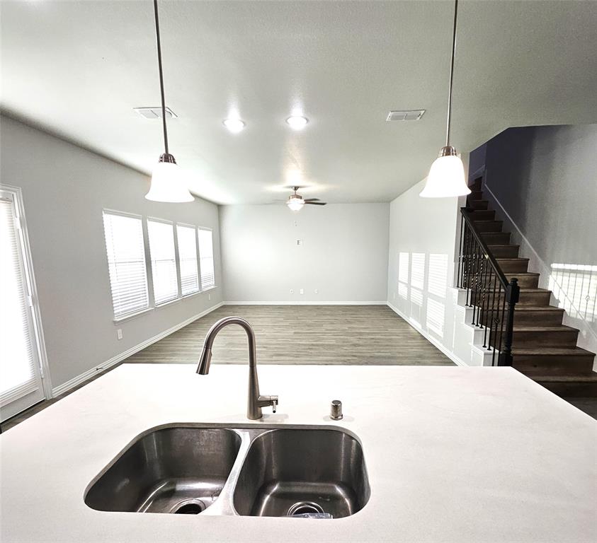Kitchen island with a double basin stainless steel sink and gooseneck faucet
