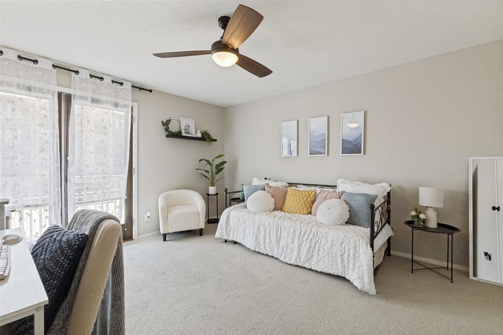 Recessed lighting, ceiling fan with wood-finish blades, and neutral-toned carpeting