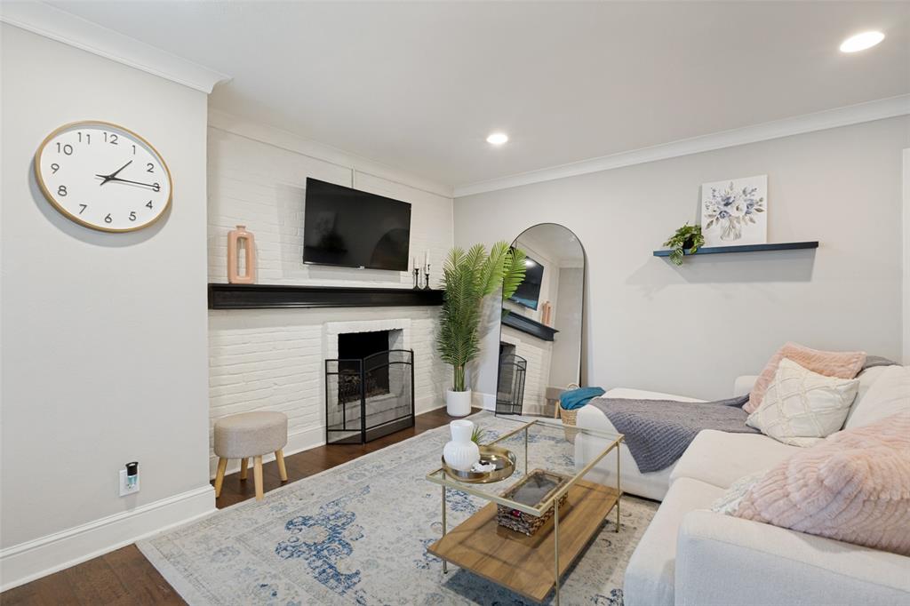 Painted brick fireplace with a dark wood mantel