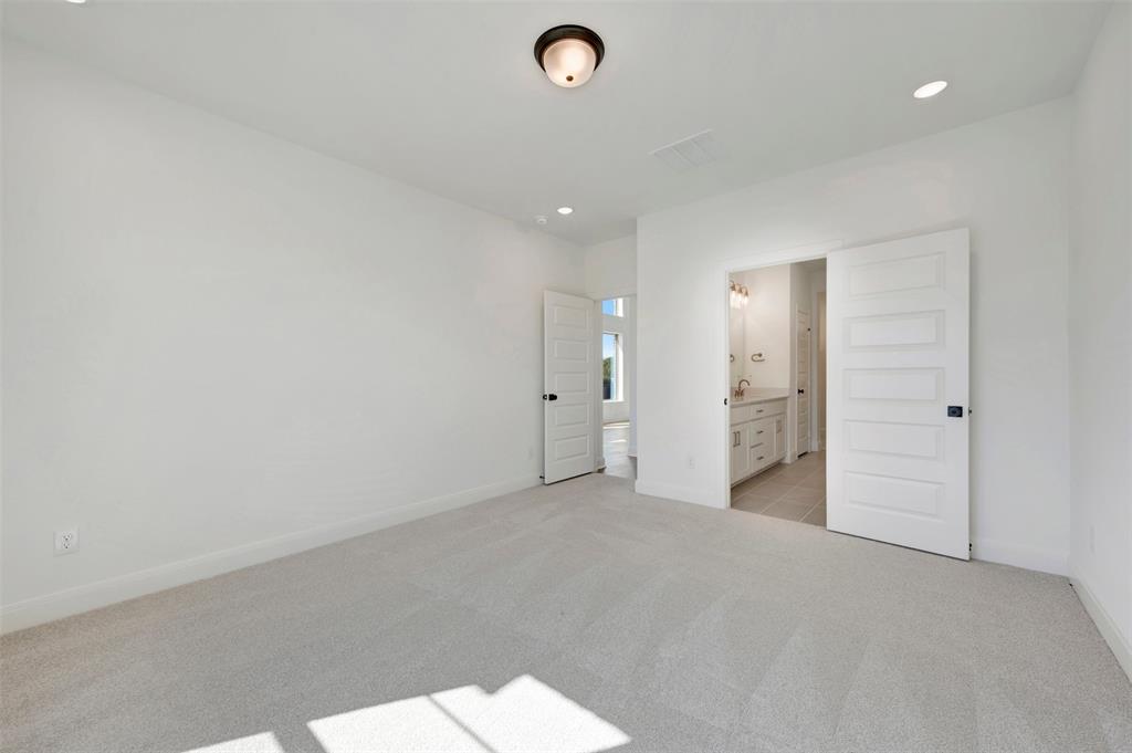 Neutral-toned carpeting with recessed lighting and a ceiling-mounted light fixture Neutral-toned carpeting with recessed lighting and a ceiling-mounted light fixture