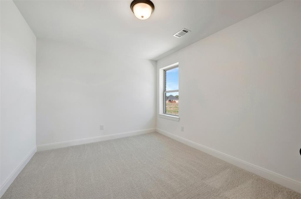 Recessed window with white trim, light-colored carpeting, white painted walls, and a flush-mount ceiling light fixture