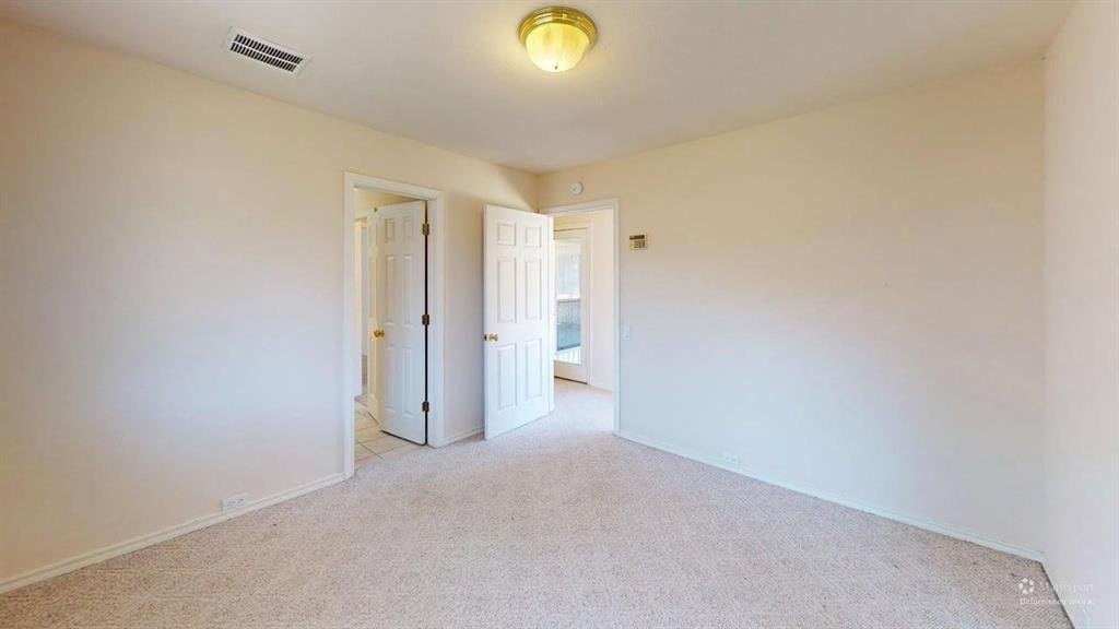 Neutral-toned walls complement plush carpeting