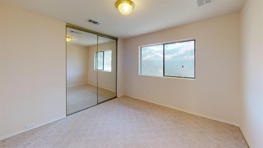 Recessed lighting, mirrored closet doors, and broad window