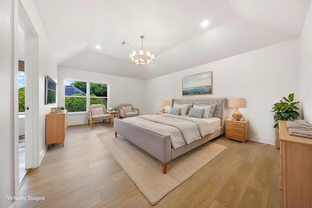 Vaulted ceiling with recessed lighting and a contemporary chandelier