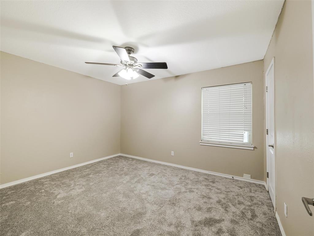 Recessed window with horizontal blinds, ceiling fan with integrated lighting, and neutral wall color