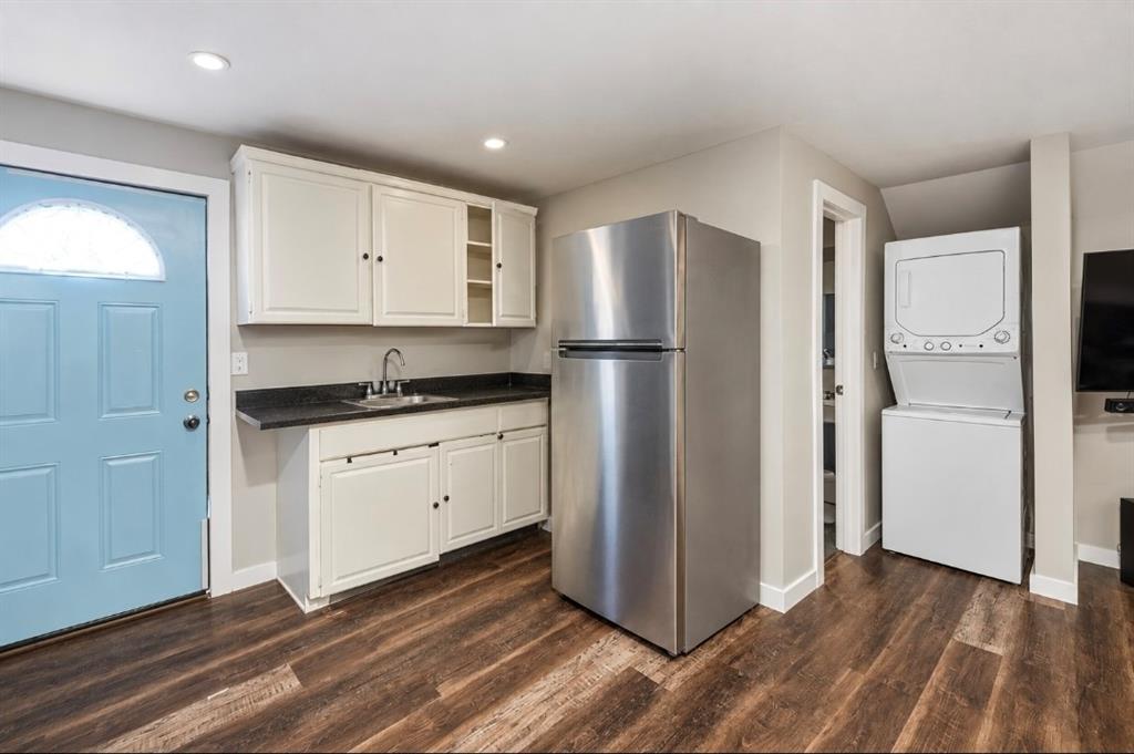 Virtually enhanced. kitchen and laundry in studio