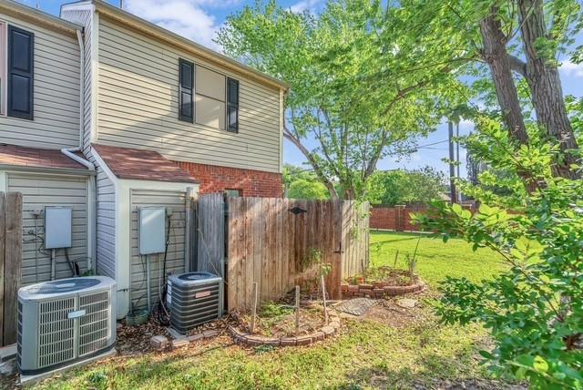 Siding exterior with brick accents, wood fencing, and established trees Siding exterior with brick accents, wood fencing, and established trees