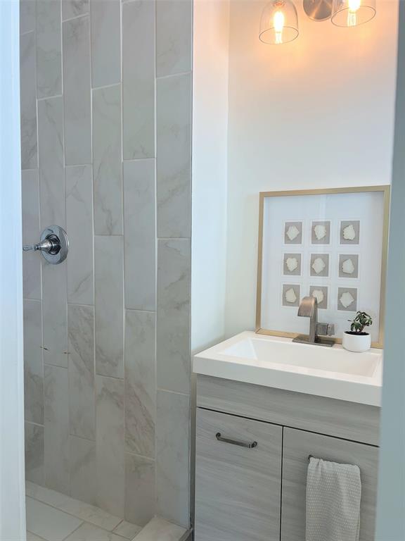 Tiled shower surround with a chrome shower control