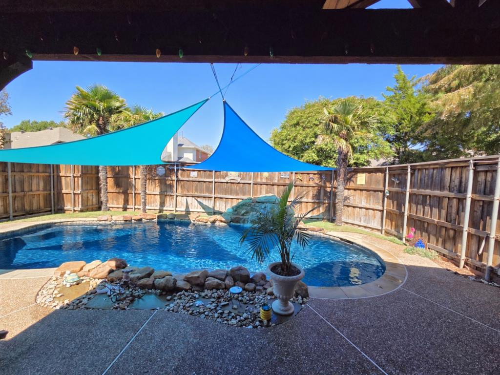 Swimming pool with rock features and water cascade