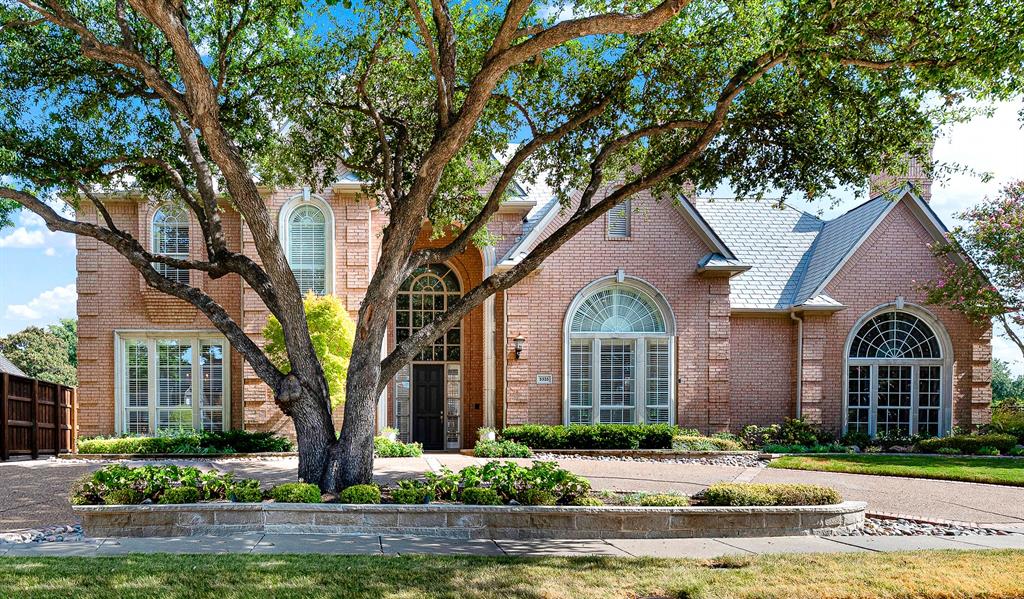 Framed by mature oak shade trees, this classic brick elevation features towering arched windows and a circular drive. You will love greeting neighbors from the sweeping front drive as soft afternoon light filters through the trees.
