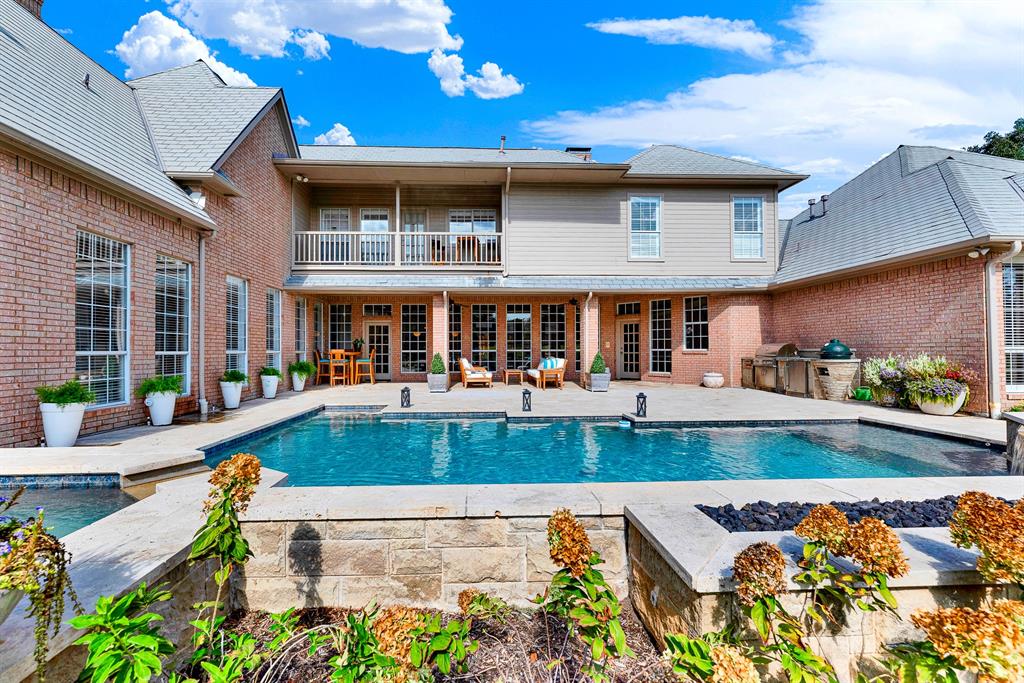 A spacious covered patio and expansive pool deck seamlessly bridge indoor-outdoor living, anchored by a stone fire pit. Host unforgettable summer barbecues while kids swim and guests gather comfortably by the fire pit.