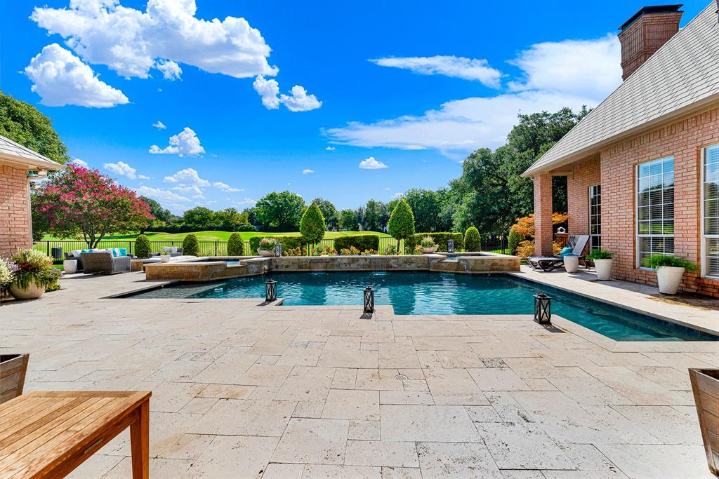 Paved travertine coping framing the resort-style pool opens directly to serene, green views of the surrounding course. Sip your morning coffee in total peace as you soak in uninterrupted golf course panoramas