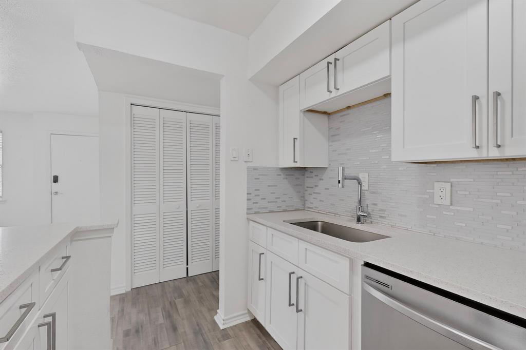 Kitchen with quartz countertops and white cabinets