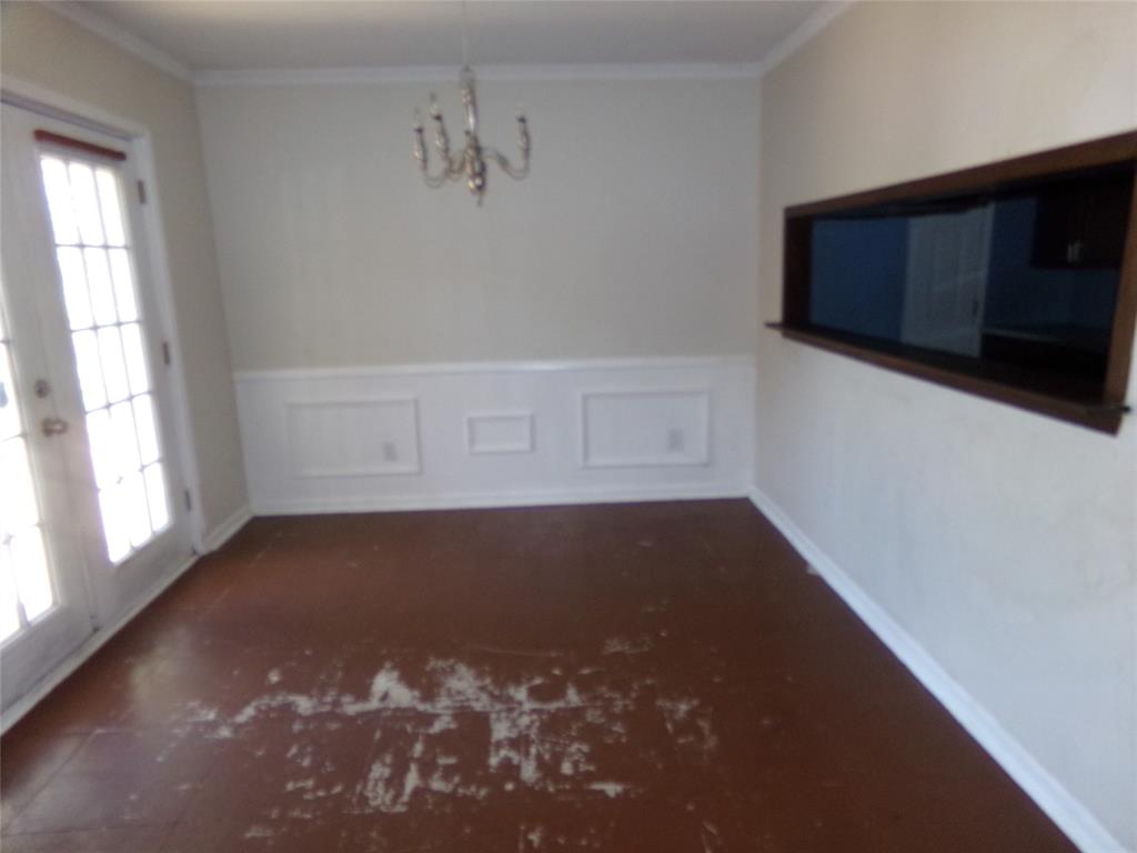 White wainscoting and crown molding accent the walls White wainscoting and crown molding accent the walls