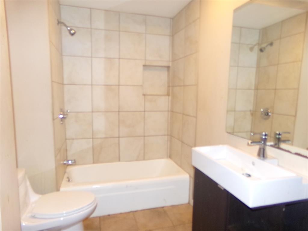 Wall-mounted vanity with a rectangular basin sink, chrome faucet, and integrated mirror