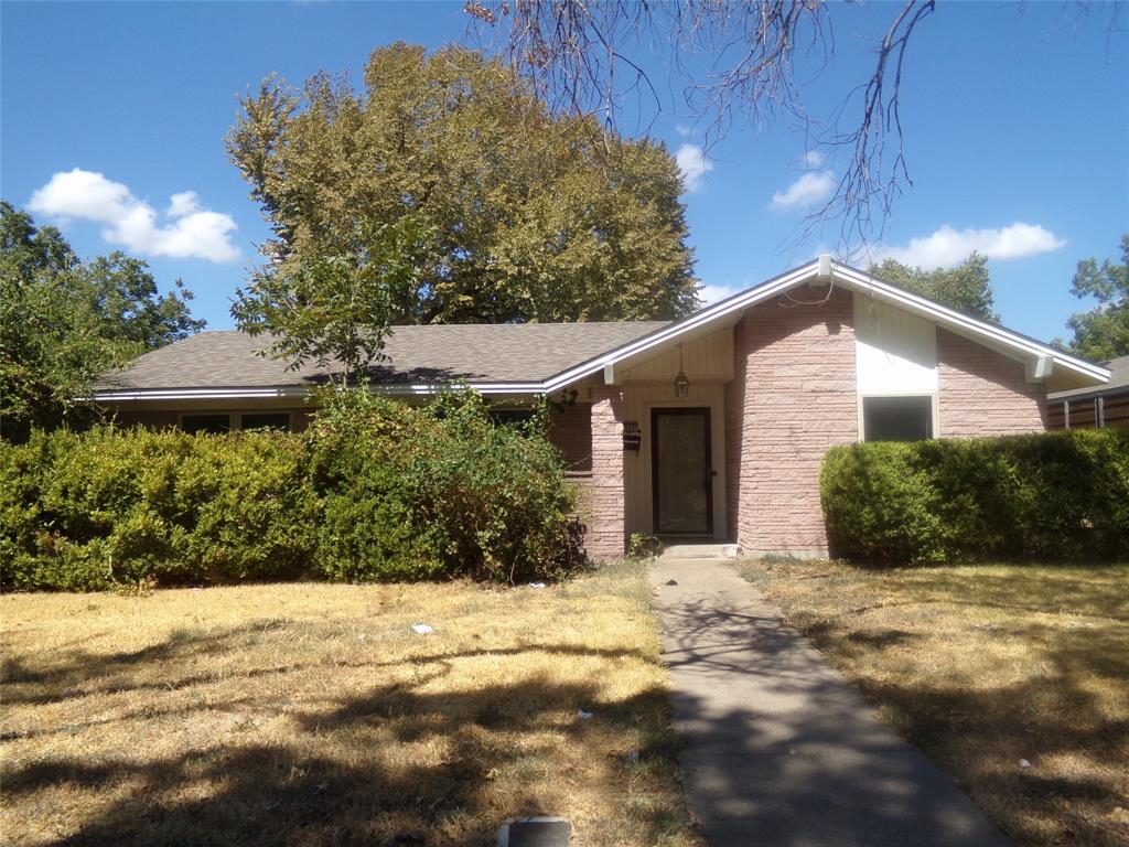 Brick facade, gabled roofline, concrete walkway, front entry door, established landscaping