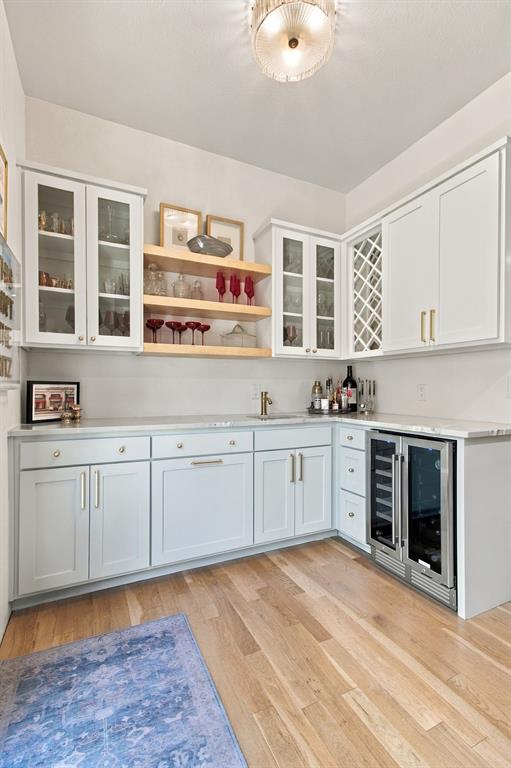 Light wood-finish flooring with a built-in beverage refrigerator