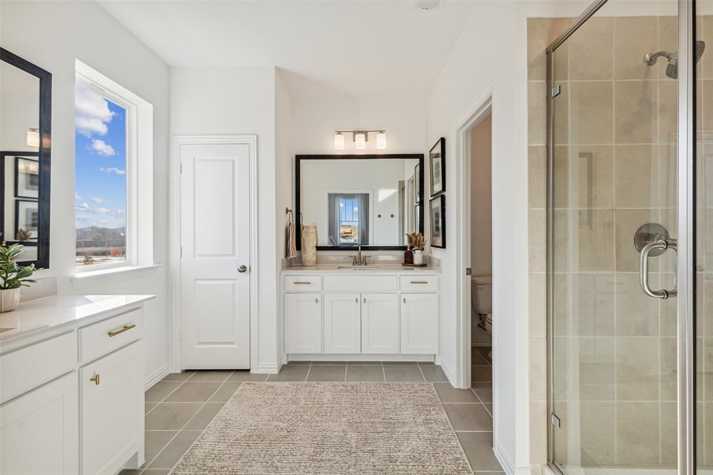 Featuring his and her vanities, this lovely owner's suite has ample room for two!